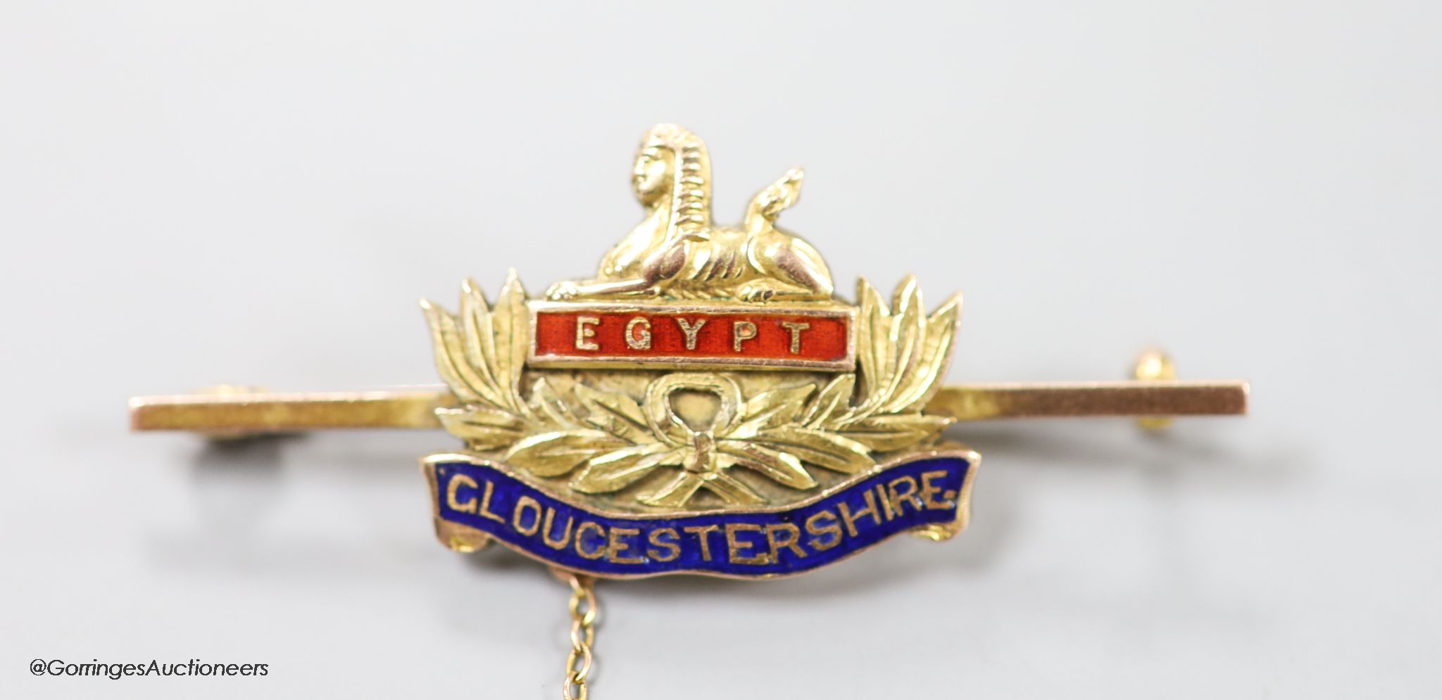 An early 20th century 9ct and enamel 'Egypt Gloucestershire' sweethearts brooch, 47mm, gross weight 7.6 grams.